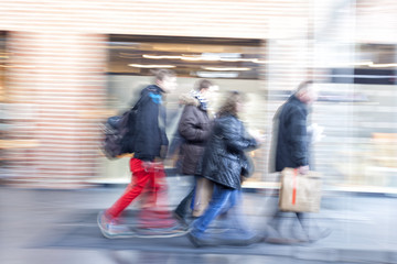 A shopper walking past a store window