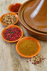 Moroccan tahine with four bowls with spices on teak table top
