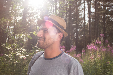 Outdoor lifestyle portrait of young hipster man wearing vintage