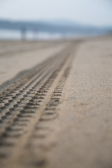 Car trail on sand