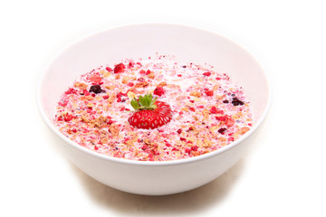 muesli with milk served in a ceramic bowl