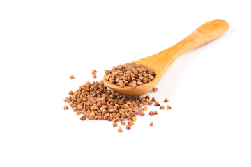 Uncooked buckwheat on wooden spoon