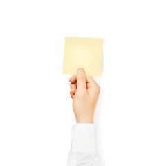 Fototapeta premium Hand holding square blank yellow sticker mock up isolated. 