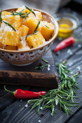 Crunchy croutons in bowl with rosemary