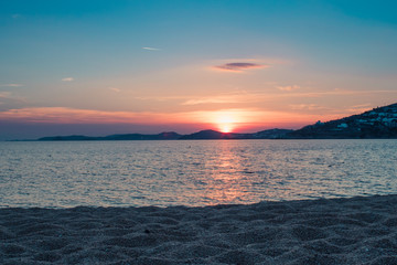 Sunset by the sea at the beach in Mykonos