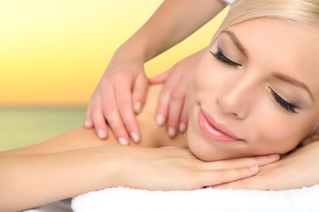 Obraz na płótnie Canvas Beautiful young woman getting massage in spa salon