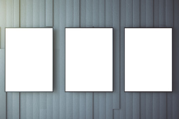 Blank white posters on grey wall, mock up