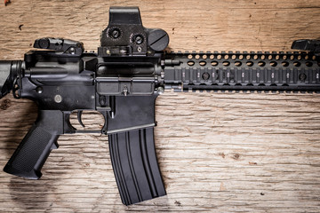 Assault rifle on a wooden table