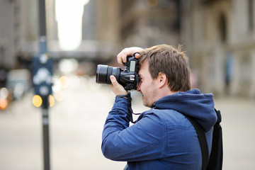 Fototapeta na wymiar Photographer taking photo with professional digital camera