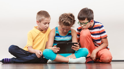 Children playing on tablet.