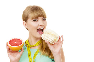 Woman choosing fruit or cake make dietary choice