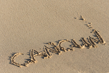 Inscription Cancun on sandy beach