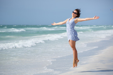 Fototapeta na wymiar Beautiful woman jumping on Florida Beach