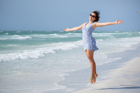 Beautiful woman jumping on Florida Beach