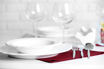 Table set at restaurant on light background
