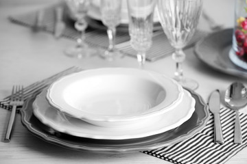 Table set at restaurant on light background