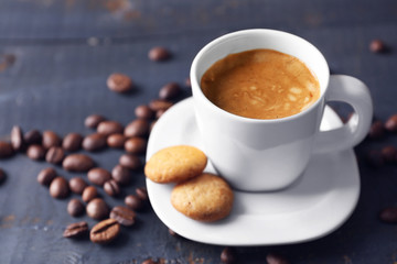 Cup of coffee on wooden table background