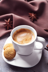 Cup of coffee on wooden table background