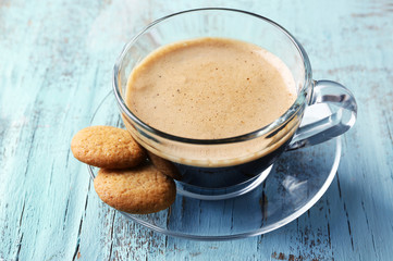 Cup of coffee on color wooden background