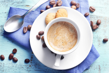 Cup of coffee on color wooden background