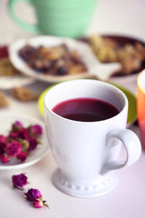 Cup of tea with aromatic dry tea on wooden background