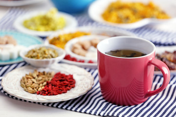 Cup of tea with aromatic dry tea on wooden background