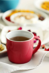 Cup of tea with aromatic dry tea on wooden background