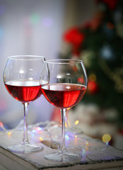 Two glasses of red wine on Christmas decoration background