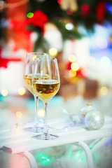 Two glasses of wine on Christmas decoration background
