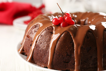 Chocolate cake with snow ball tree berries on plate on a table