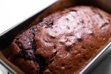Chocolate cake in baking dish on white table