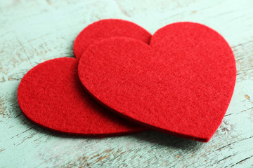 Obraz premium Red felt hearts on blue wooden background