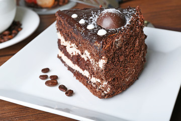 Piece of chocolate cake in white plate closeup