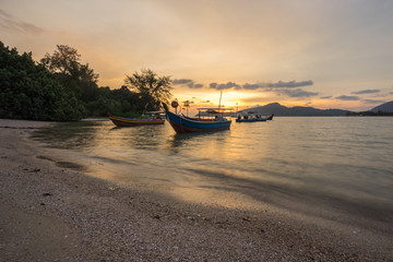 Fisherman boat at the beach during sunset