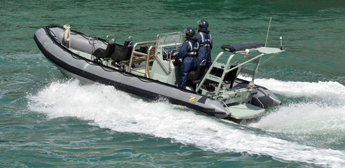 Royal New Zealand navy sailors ride a Zodiak Rigid-hulled inflat