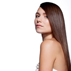 Fototapeta premium Woman with long smooth shiny dark hair and bare shoulders on a white background