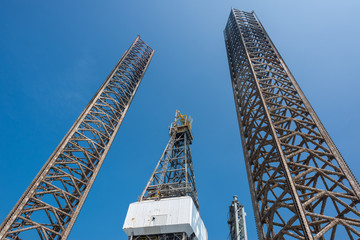 Two jack up oil rig leg and derrick with blue sky when almost fu