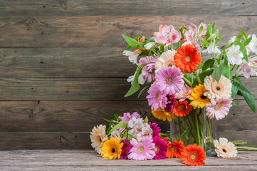 Fototapeta na wymiar Fresh Gerbera Flowers on Wooden Background