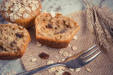 Fototapeta na wymiar Vintage photo, Fresh muffins with oatmeal baked with wholemeal flour and ears of rye grain, delicious healthy dessert