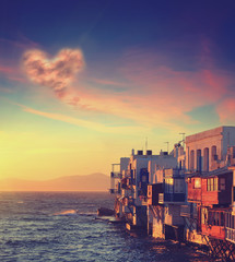 Colorful Little Venice of Mykonos island at sunset , Greece with cloud in form of heart. Business,...