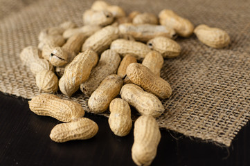 Peanuts scattered on a jute fabric