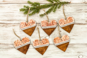 Hanging decoration shaped hearts on christmas tree.