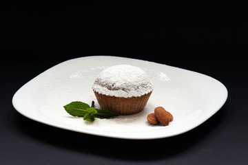 Peppermint cupcake. Sweet cupcake. Close up of mint cupcake. Muffin. Fresh delicious homemade cupcake. Cupcake with mint and frosting on top with powdered sugar. Shallow depth of field.