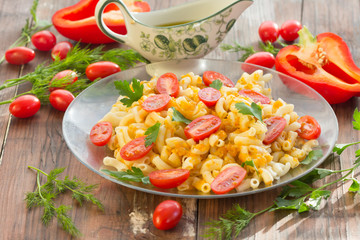 Macaroni pasta in vegetable sauce with fresh tomatoes and parsley on wooden dark background. Vegetarian o healthy food concept