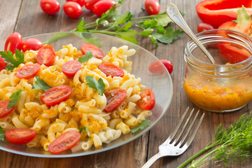 Macaroni pasta in vegetable sauce with fresh tomatoes and parsley on wooden dark background. Vegetarian o healthy food concept
