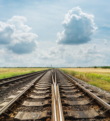 Fototapeta premium crossing of railways closeup under cloudy sky