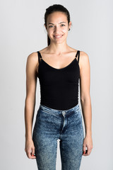 Young woman wearing black tank top and blue jeans