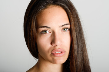 Beautiful young woman without make-up on white background