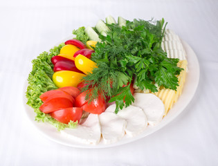Fresh vegetables and various cheeses.
