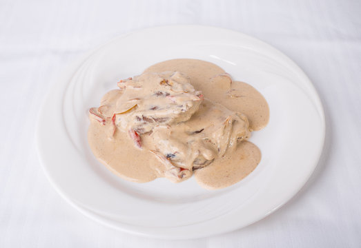Grilled meat covered with mushroom sauce.